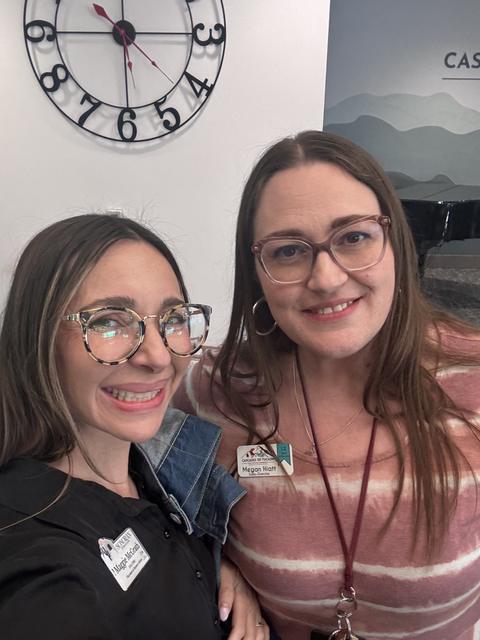 Two members smile together after the meeting